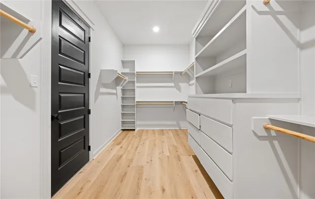 a view of walk in closet with empty racks
