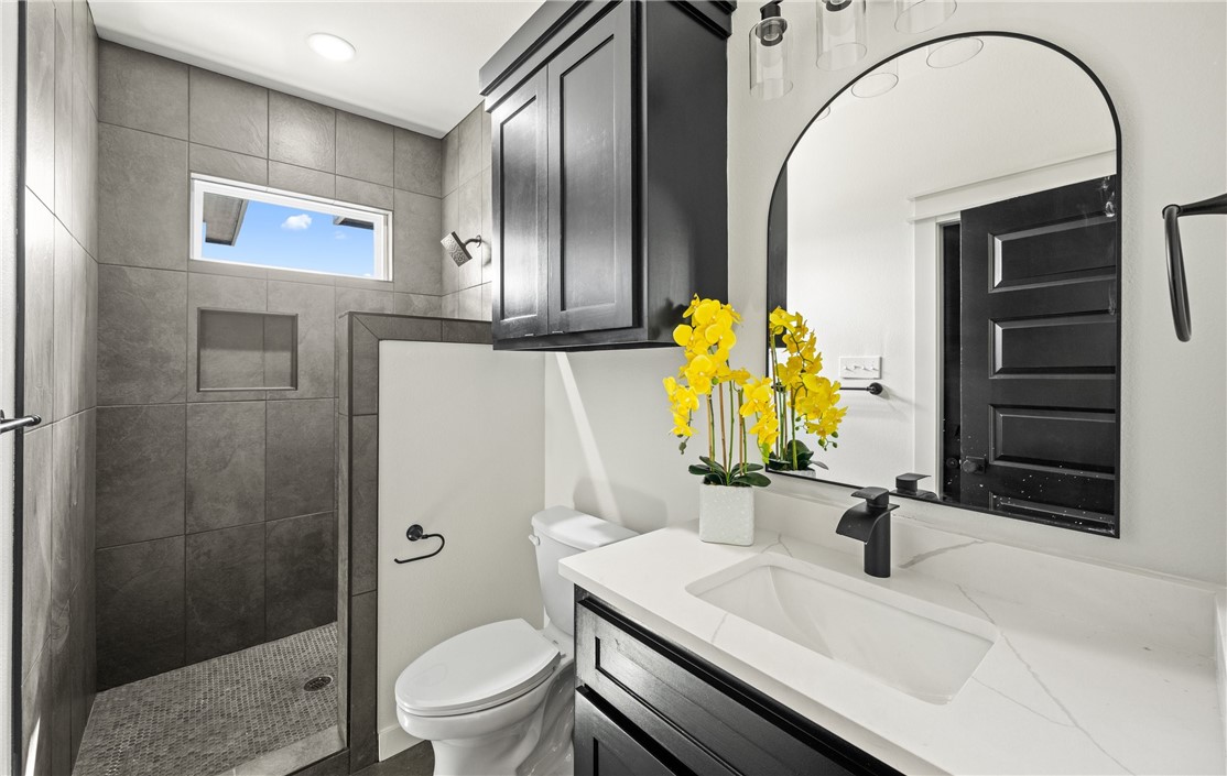 1517 Fenner Ranch Corpus Christi, TX 78415 - Photo 26 of 34 a bathroom with a sink a toilet and shower