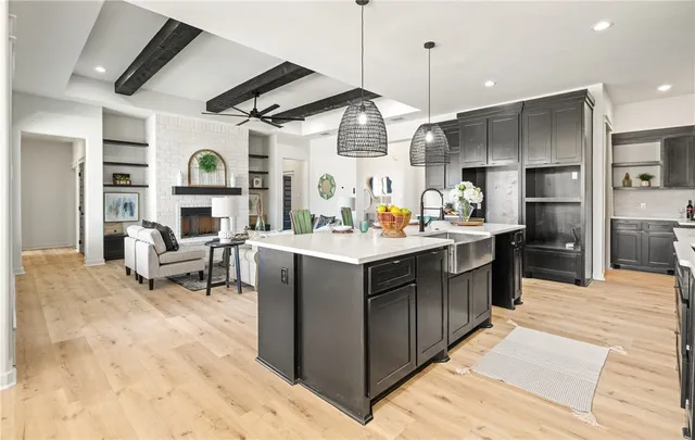 a living room with stainless steel appliances kitchen island granite countertop furniture and a view of living room