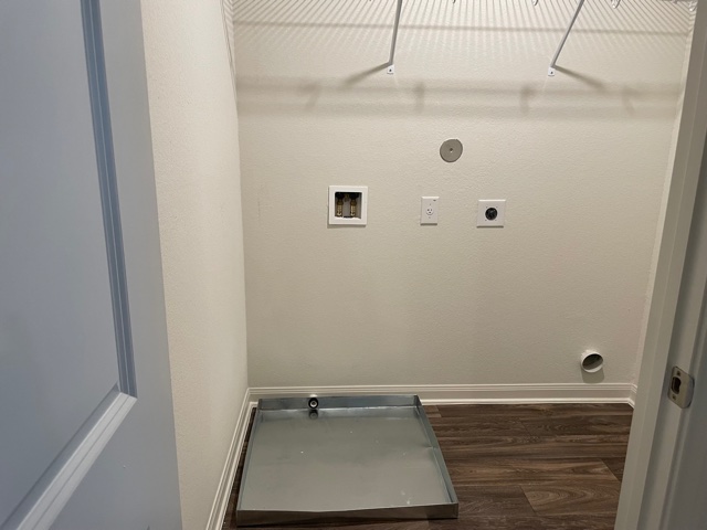 18741 Speculator Lane Elgin, TX 78621 - Photo 24 of 28 Laundry area featuring dark wood-style flooring, electric dryer hookup, and hookup for a washing machine