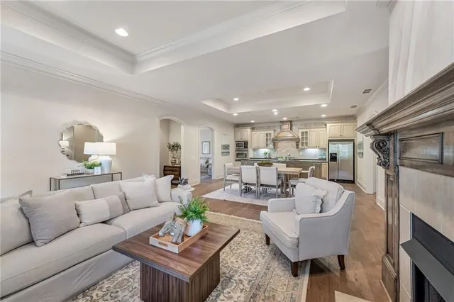 a living room with furniture kitchen view and a table