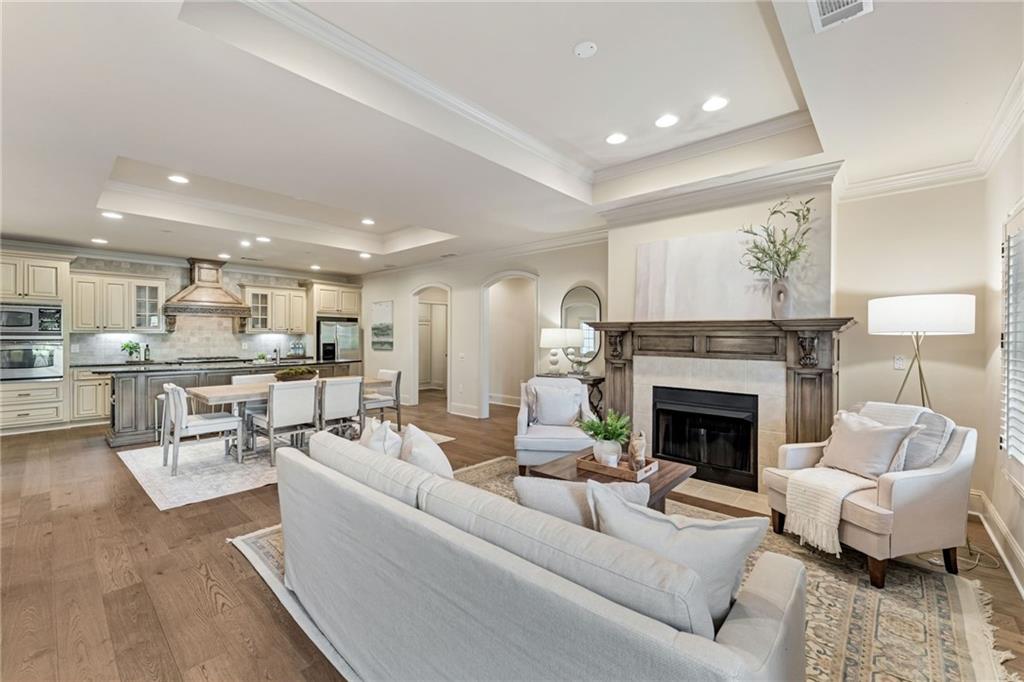 2550 Ballantrae Circle, Unit 53F Cumming, GA 30041 - Photo 2 of 46 a living room with furniture and a fireplace