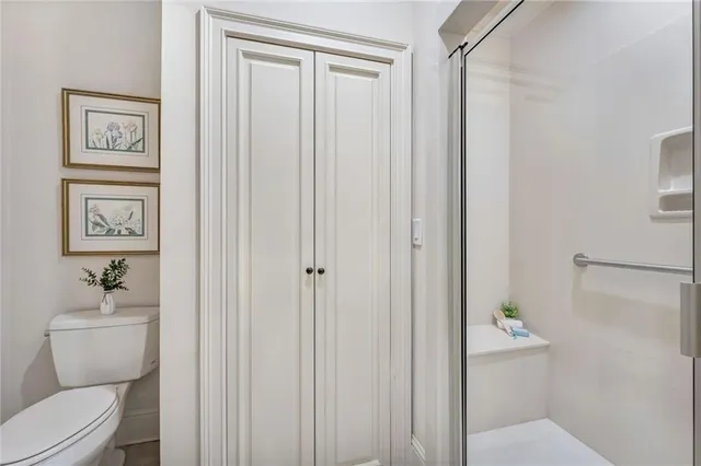 a bathroom with a toilet and a shower