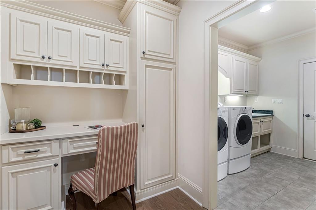 2550 Ballantrae Circle, Unit 53F Cumming, GA 30041 - Photo 25 of 46 a utility room with cabinets washer and dryer