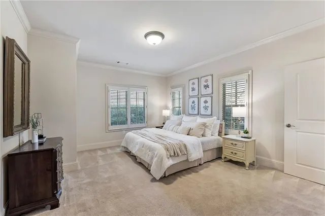 a spacious bedroom with a bed and a lamp