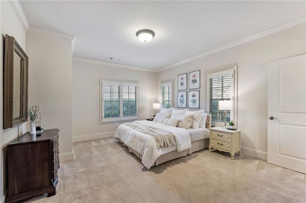 2550 Ballantrae Circle, Unit 53F Cumming, GA 30041 - Photo 26 of 46 a bedroom with a bed and a dresser