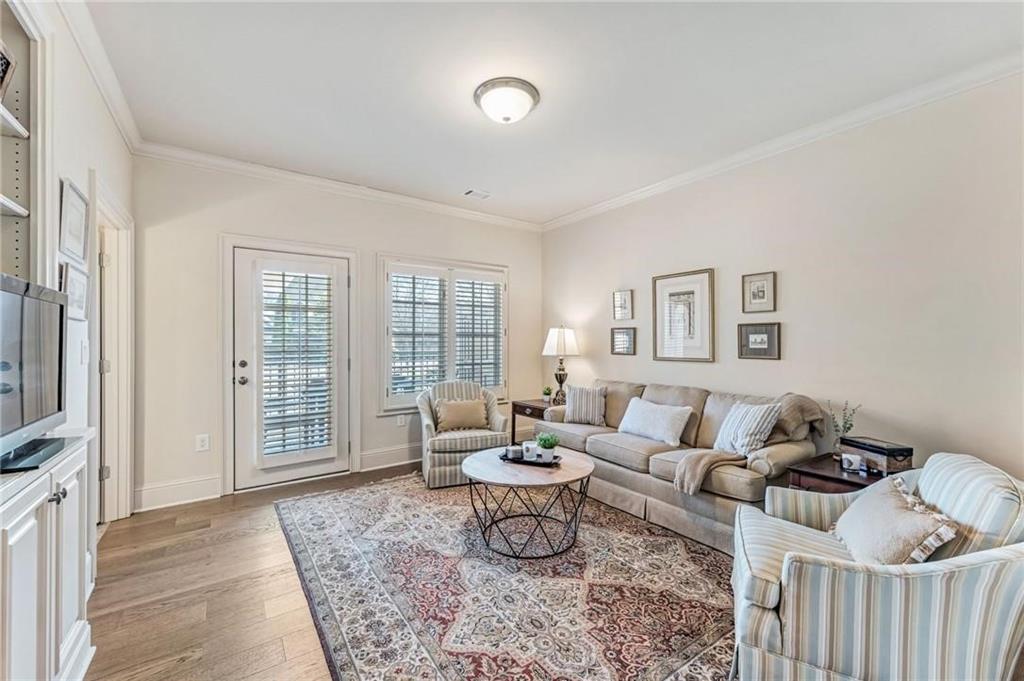 2550 Ballantrae Circle, Unit 53F Cumming, GA 30041 - Photo 30 of 46 a living room with furniture and a window