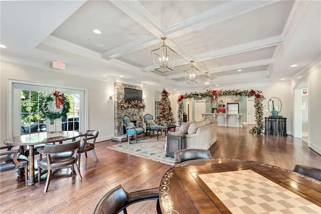 a view of a hallway with dining area and chandelier