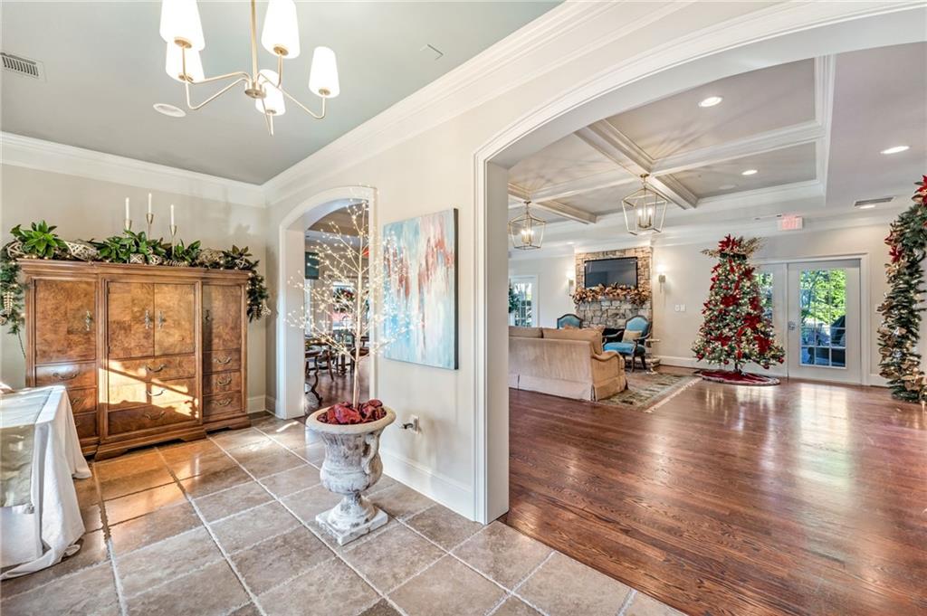 2550 Ballantrae Circle, Unit 53F Cumming, GA 30041 - Photo 39 of 46 a view of a hallway with dining area and chandelier