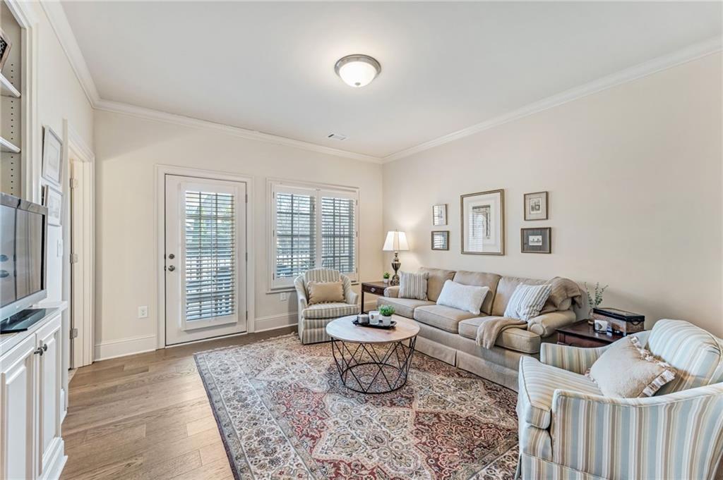 2550 Ballantrae Circle, Unit 53F Cumming, GA 30041 - Photo 4 of 46 a living room with furniture and a window