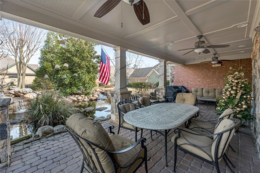 2550 Ballantrae Circle, Unit 53F Cumming, GA 30041 - Photo 42 of 46 a view of a porch with furniture and a yard