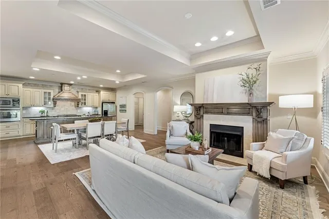 a kitchen with stainless steel appliances granite countertop table chairs stove and refrigerator