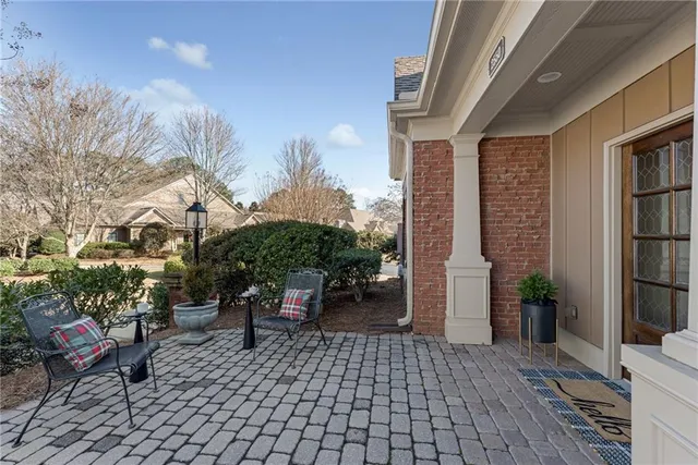 a view of a patio with table and chairs and potted plants