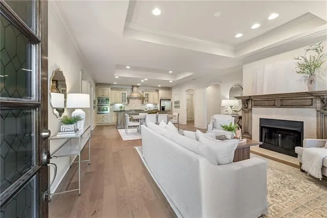 a living room with furniture a fireplace and a kitchen view