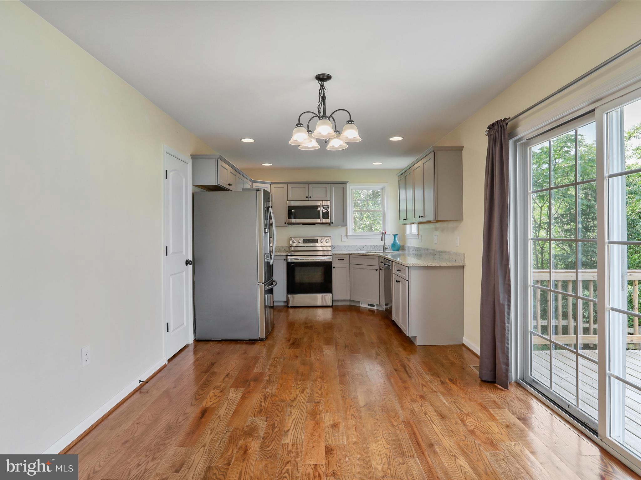 1613 Needy Road Martinsburg, WV 25405 - Photo 5 of 37 a view of a kitchen with wooden floor electronic appliances and furniture
