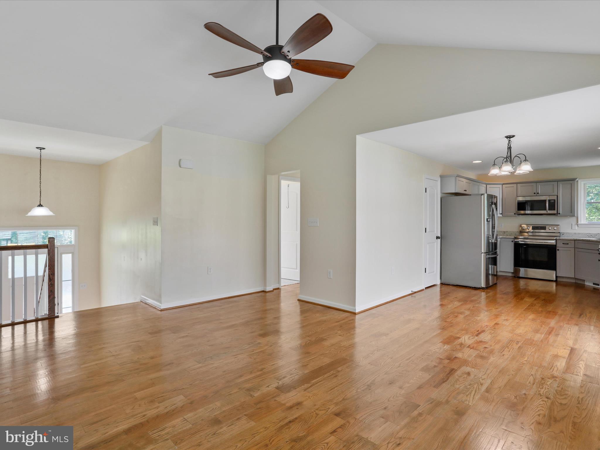 1613 Needy Road Martinsburg, WV 25405 - Photo 8 of 37 a view of a livingroom with furniture a ceiling fan and kitchen view