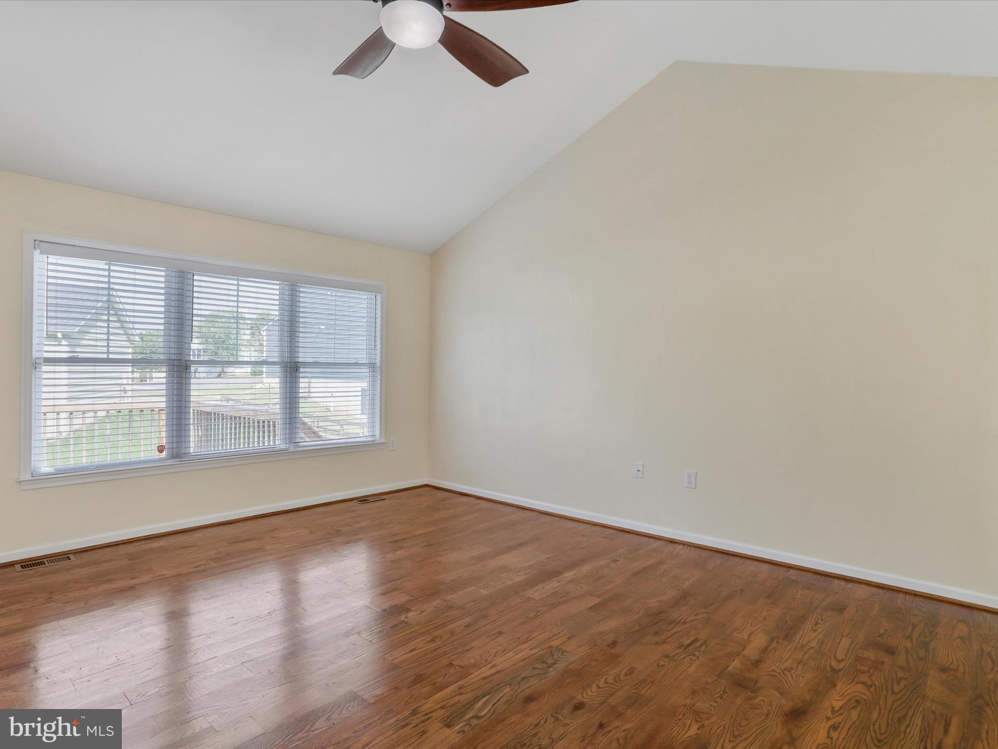 1613 Needy Road Martinsburg, WV 25405 - Photo 9 of 37 an empty room with wooden floor fan and windows