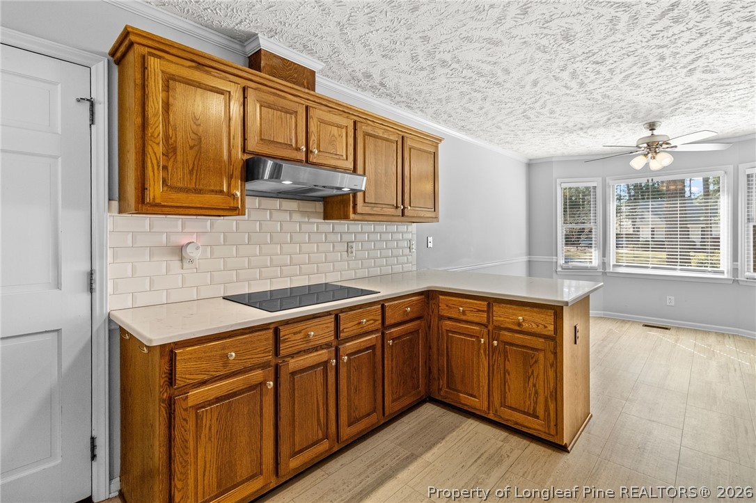 7756 Dragonhead Road Fayetteville, NC 28311 - Photo 14 of 42 a kitchen with stainless steel appliances granite countertop a sink and dishwasher a stove with wooden cabinets