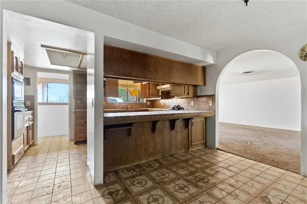 a kitchen with stainless steel appliances granite countertop a sink and cabinets