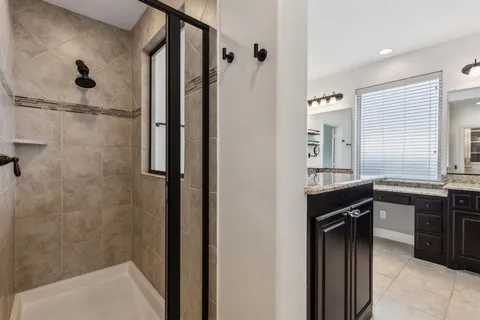 a view of a room with a ceiling fan and entryway