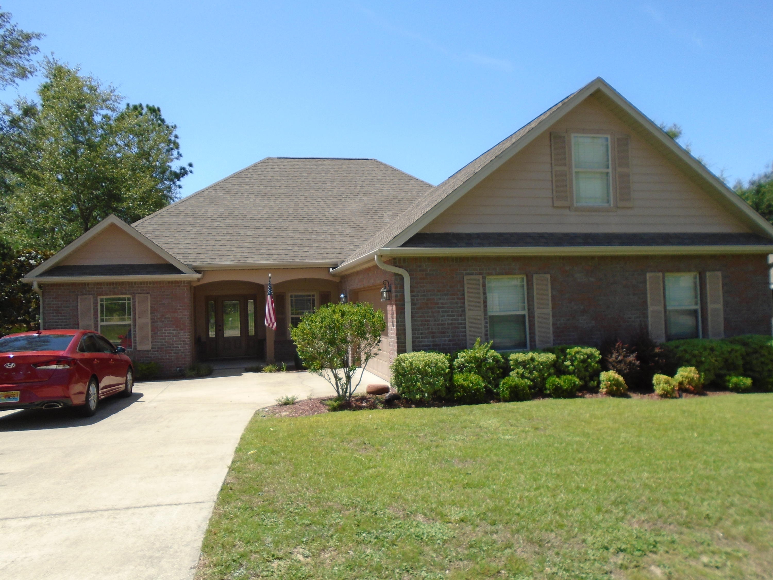 672 Red Fern Road Crestview, FL 32536 - Photo 1 of 27 a front view of a house with a yard and garage