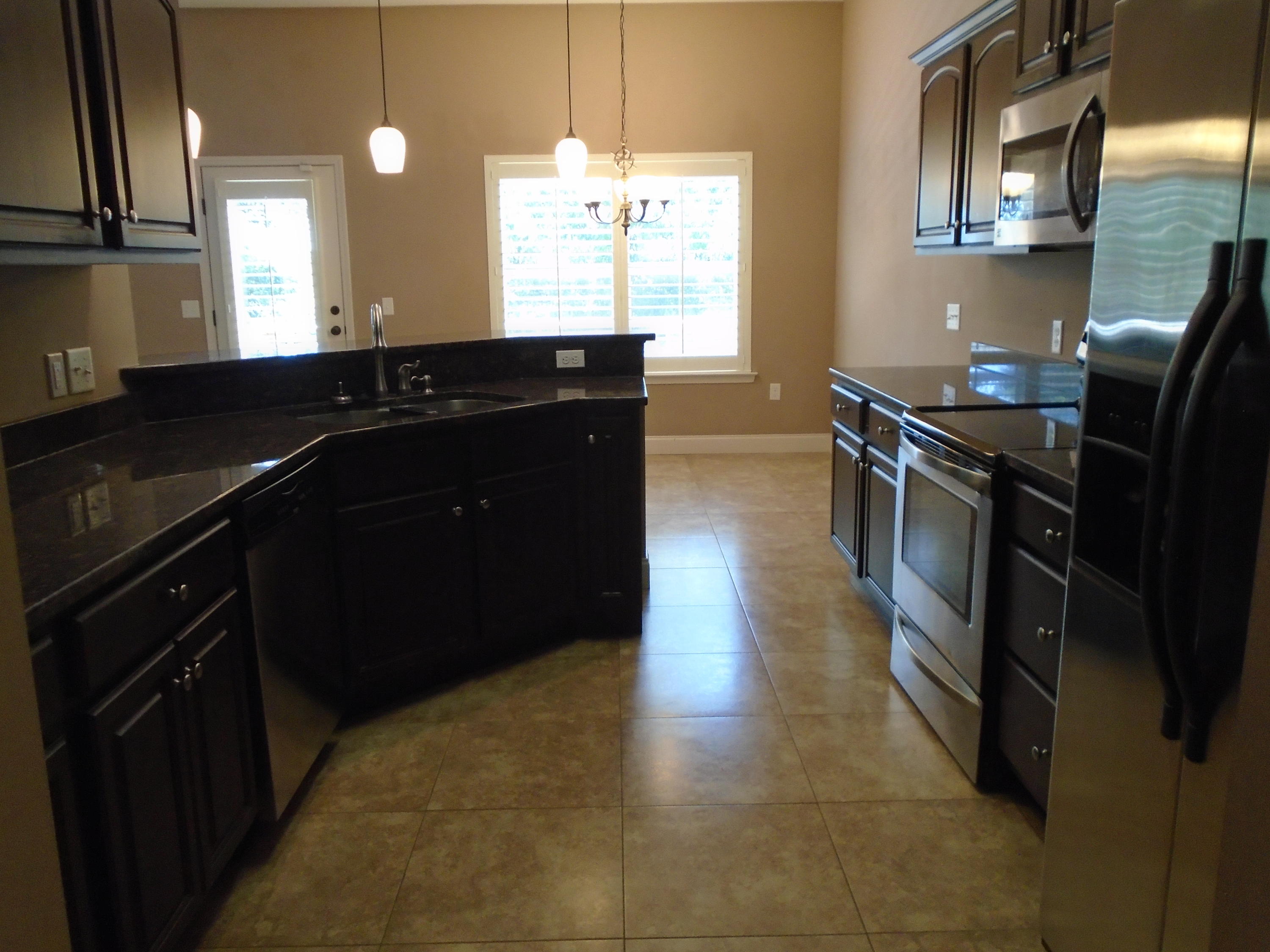 672 Red Fern Road Crestview, FL 32536 - Photo 10 of 27 a kitchen with a sink stove and cabinets