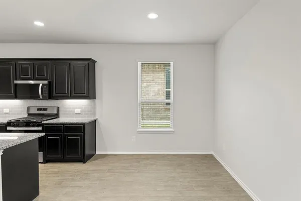 a kitchen with stainless steel appliances a stove a sink and a microwave