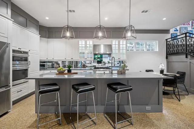 a kitchen with stainless steel appliances granite countertop a sink and cabinets