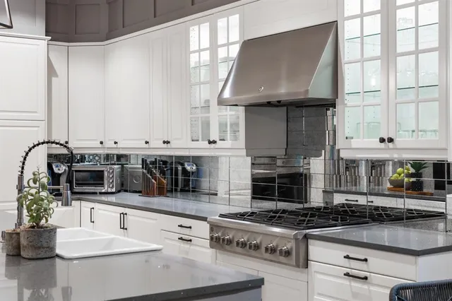 a kitchen with stainless steel appliances granite countertop a stove and a sink