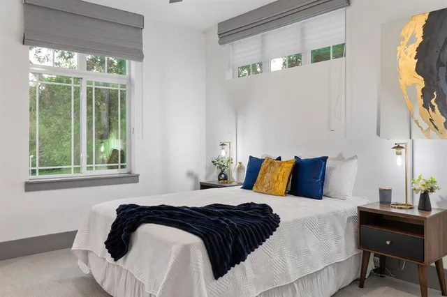 a bedroom with a bed and a window