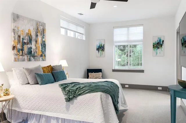 a bedroom with a bed and a window