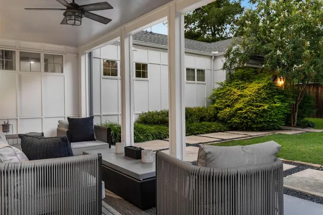 a view of a patio with couches chairs potted plants and a big yard
