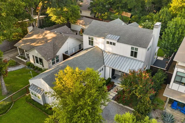 an aerial view of a house with a yard and deck