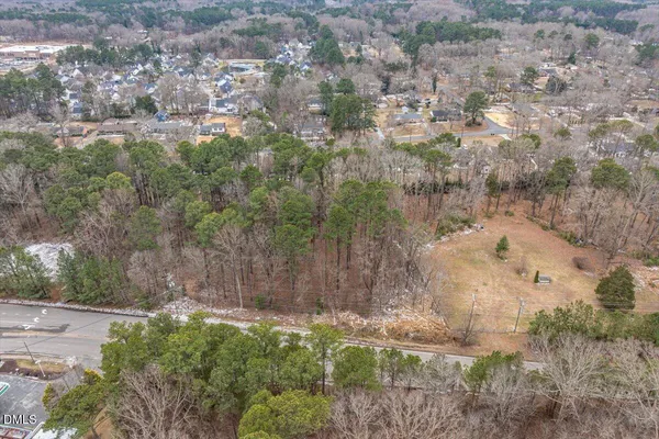 a view of a yard with large trees