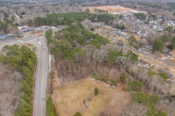 a view of a dry yard with trees