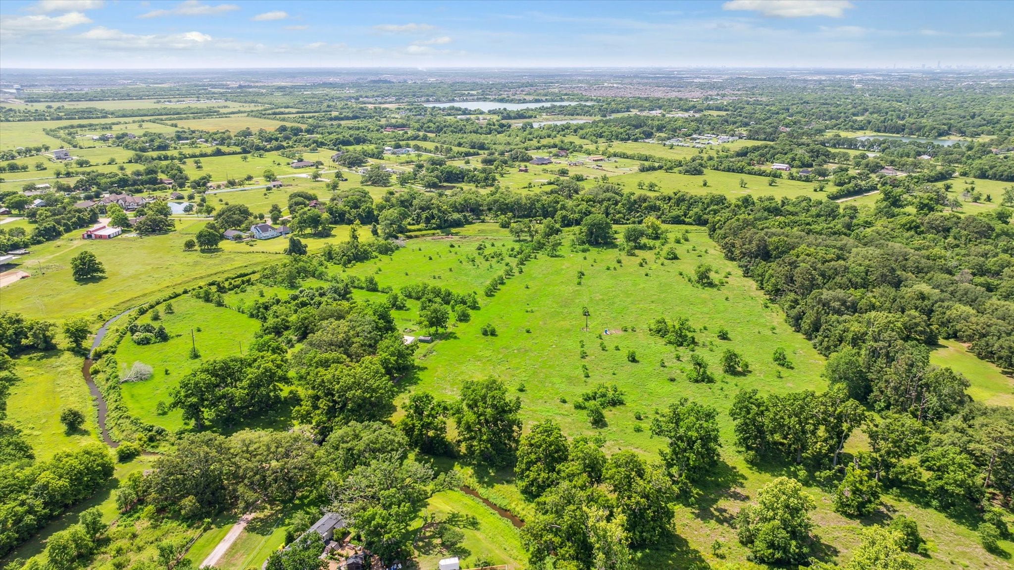 5634 Patterson Road Manvel, TX 77578 - Photo 2 of 8 a view of a city with lush green forest