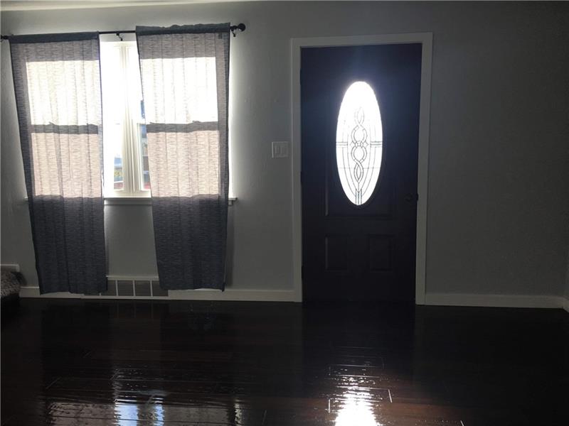Welcome family and friends and invite them into the friendly living room draped in natural sunlight from the large picture window. 