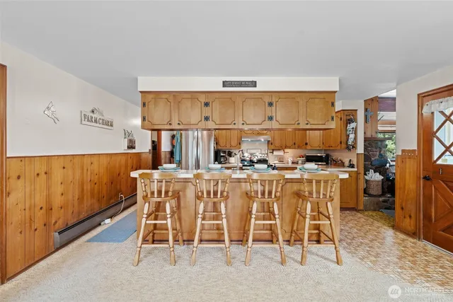 a kitchen with a sink a stove cabinets and wooden floor