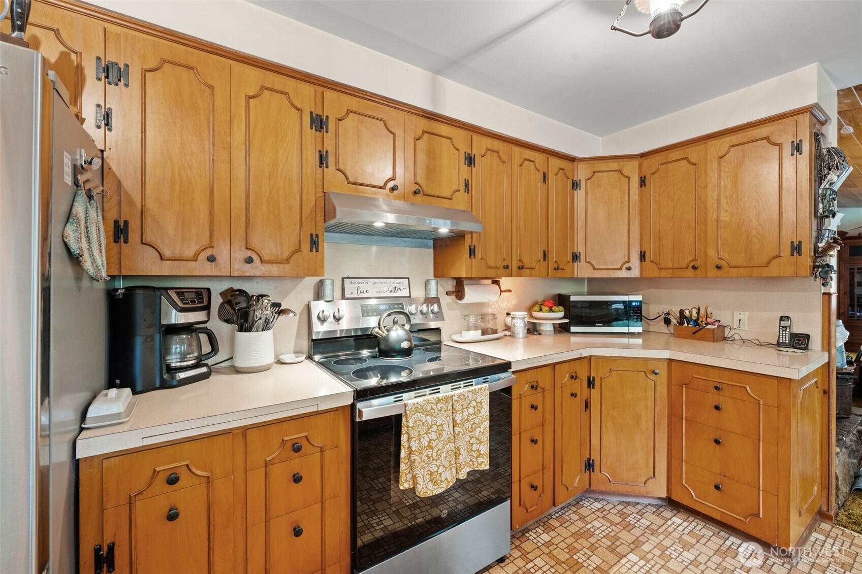 1906 164th Street South Spanaway, WA 98387 - Photo 15 of 35 a kitchen with stainless steel appliances granite countertop a stove a sink dishwasher and cabinets with wooden floor