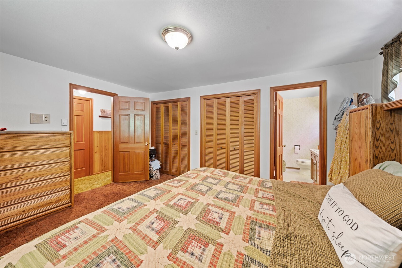 1906 164th Street South Spanaway, WA 98387 - Photo 16 of 35 a bedroom with a bed and a dresser next to a window