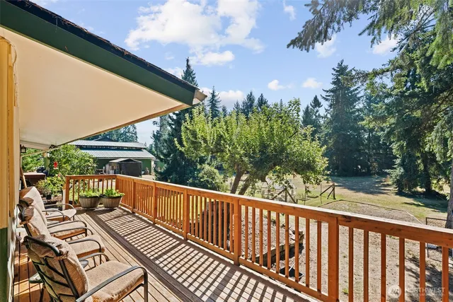 a view of a roof deck with wooden floor and fence