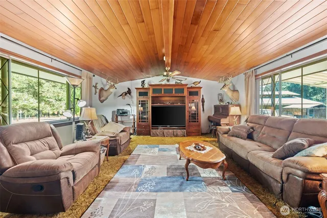a living room with furniture a fireplace and a table