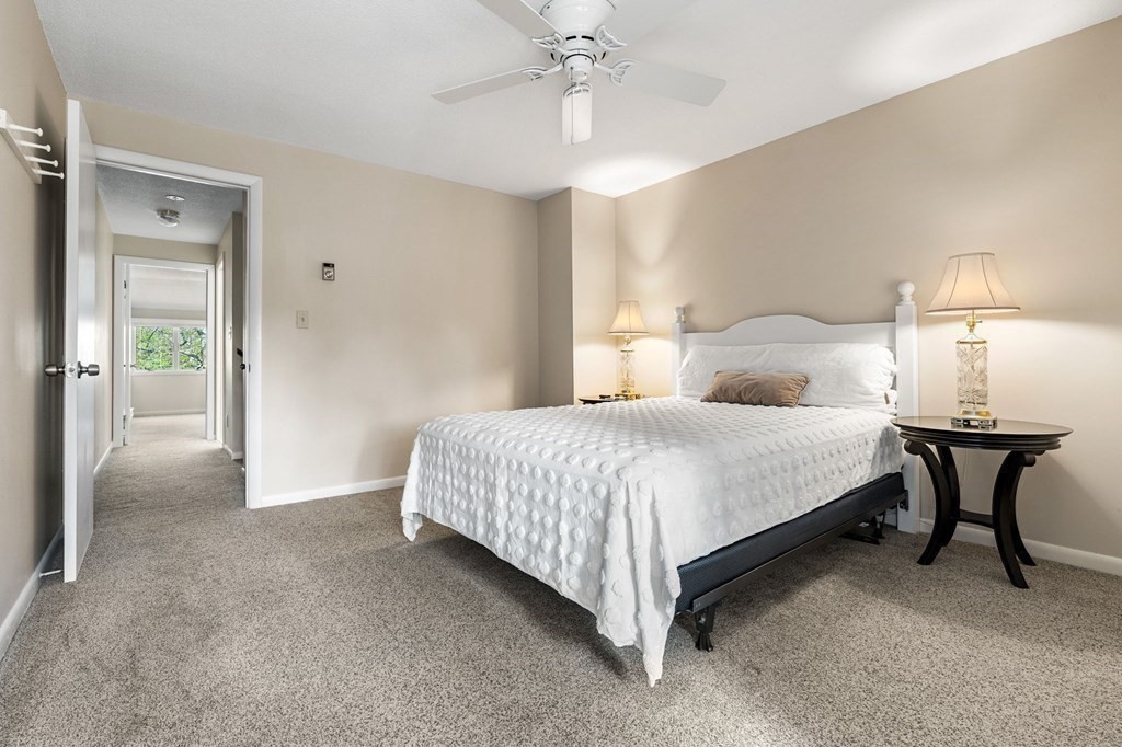 19 Atlantic Road, Unit 12 Gloucester, MA 01930 - Photo 19 of 35 a bedroom with a bed and a table