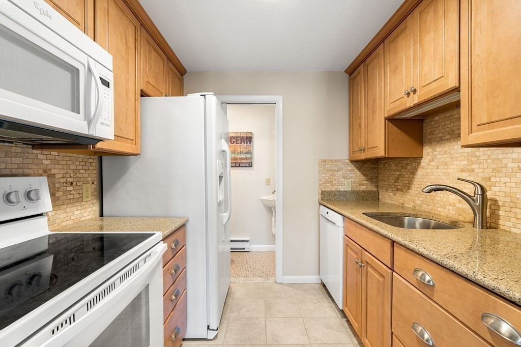 19 Atlantic Road, Unit 12 Gloucester, MA 01930 - Photo 7 of 35 a kitchen with a sink a stove and cabinets
