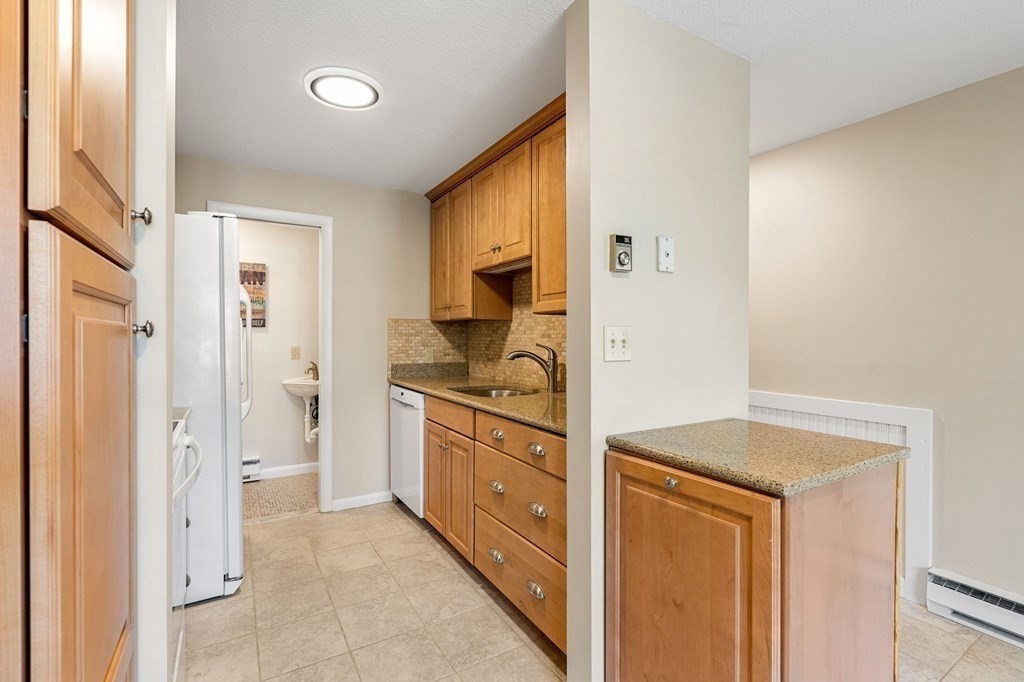 19 Atlantic Road, Unit 12 Gloucester, MA 01930 - Photo 8 of 35 a kitchen with stainless steel appliances granite countertop a refrigerator and a sink