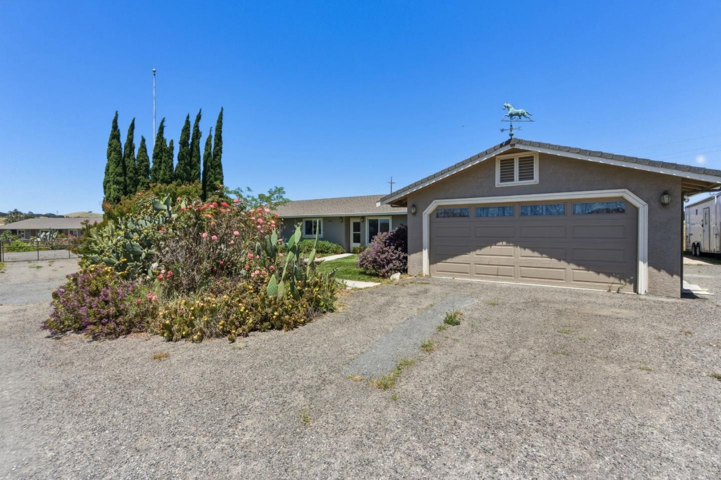 38780 Dinosaur Point Road Hollister, CA 95023 - Photo 30 of 34 a front view of a house with a yard and garage