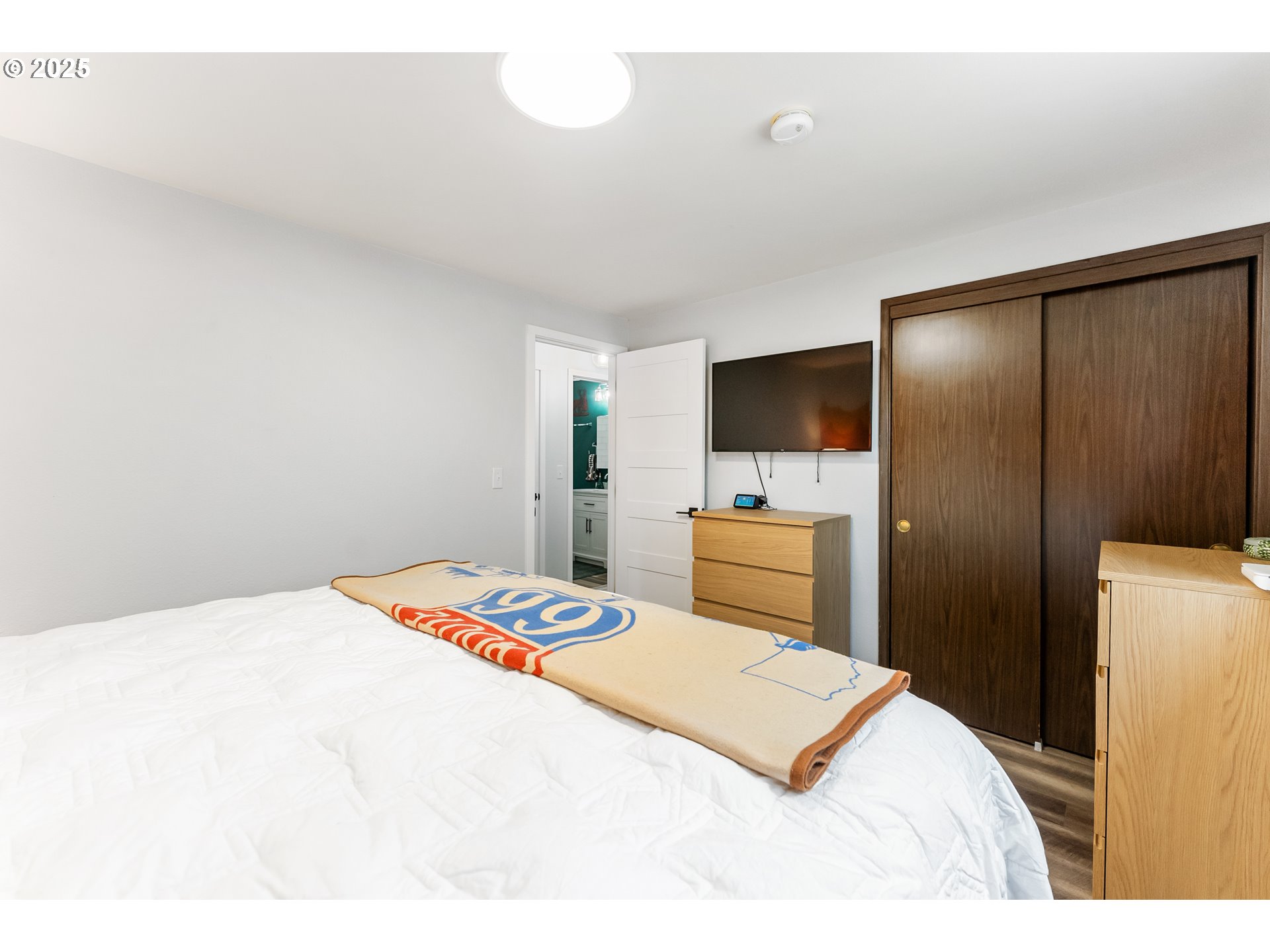 9145 Southeast Oak Street Portland, OR 97216 - Photo 12 of 27 a bedroom with a bed and a flat screen tv