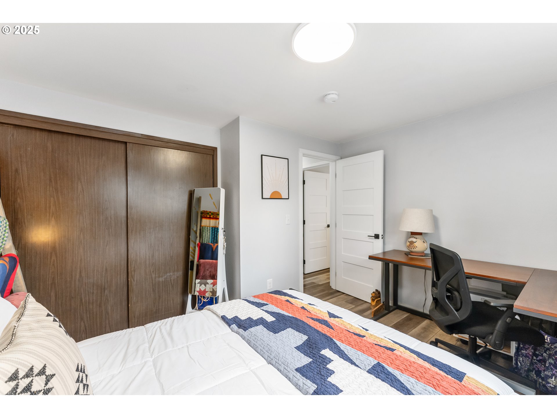 9145 Southeast Oak Street Portland, OR 97216 - Photo 15 of 27 a bedroom with a bed and a chandelier