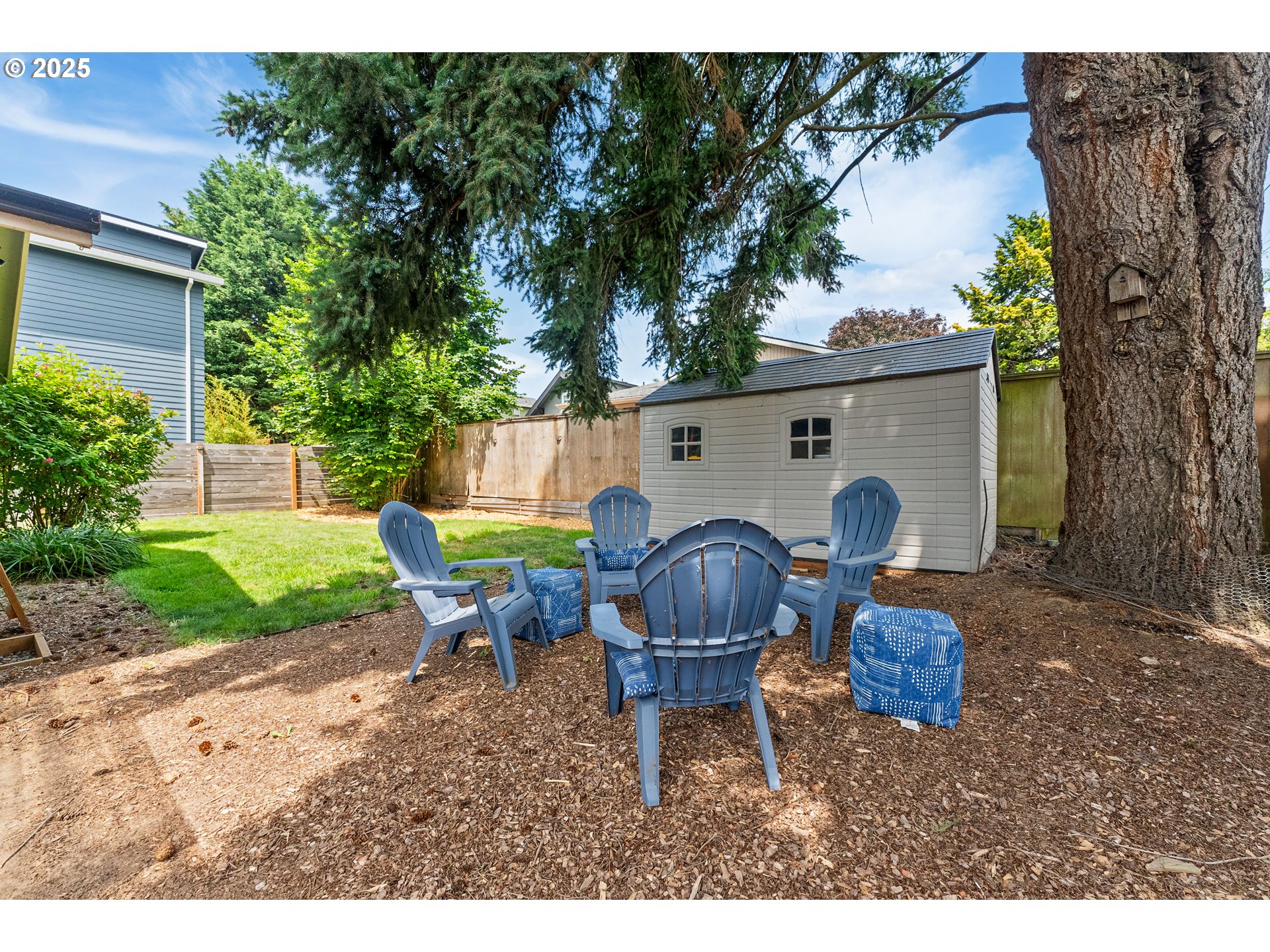 9145 Southeast Oak Street Portland, OR 97216 - Photo 20 of 27 a backyard of a house with table and chairs