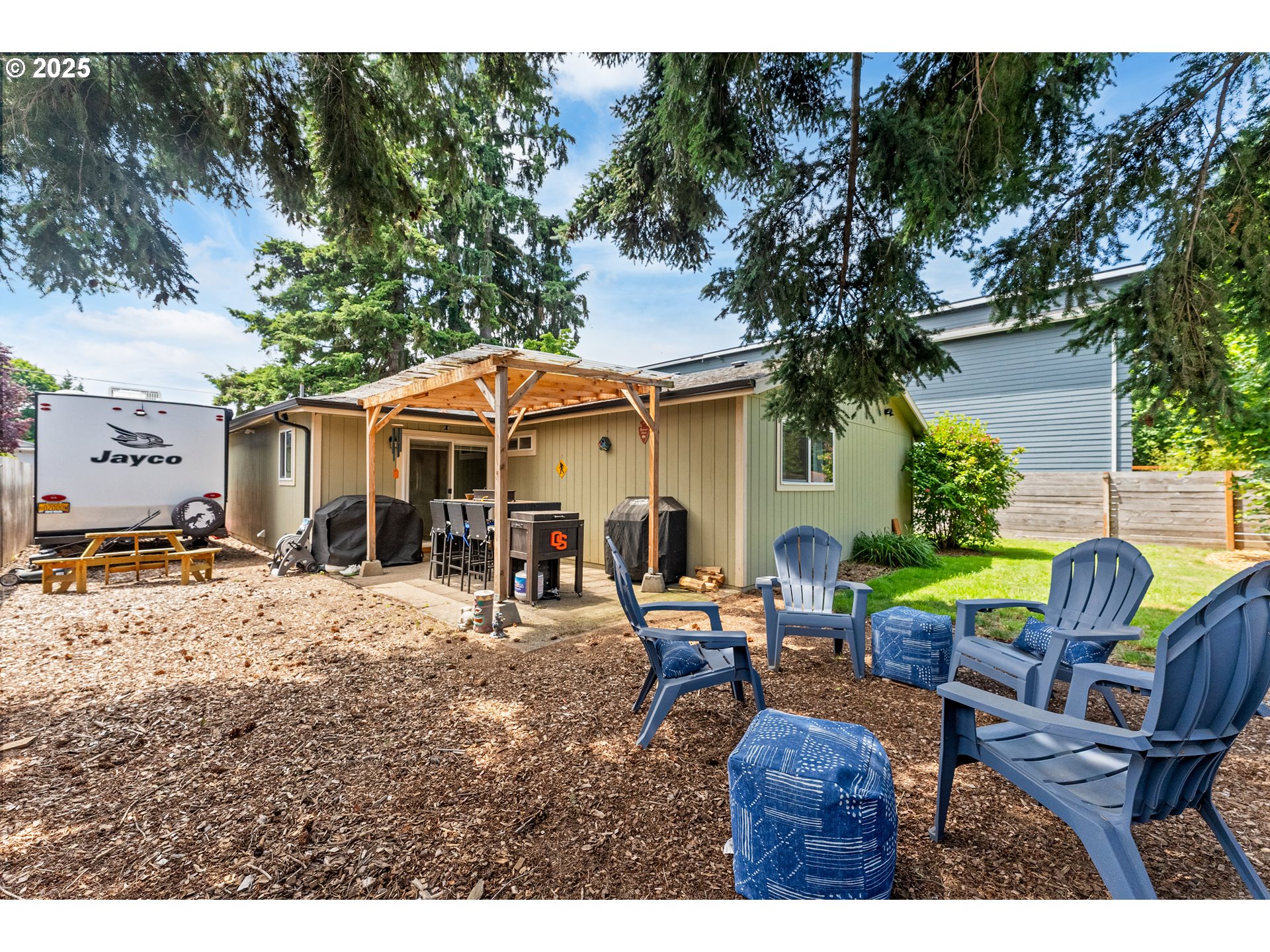 9145 Southeast Oak Street Portland, OR 97216 - Photo 21 of 27 a backyard of a house with table and chairs under an umbrella
